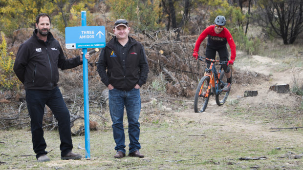 Stromlo Forest Park manager Jeff van Aalst, Canberra Off-Road Cyclists vice president Darren Stewart with mountain biker and volunteer trail builder Ryan Walsch at Three Amigos, a new trail.