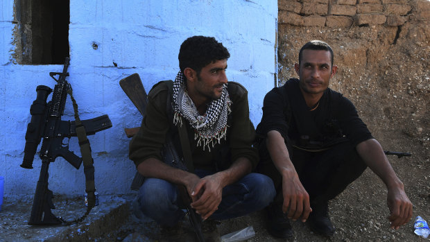 YPG soliders Maslum Hassakeh and Zenar Zenar rest at a checkpoint 10km from the front line.