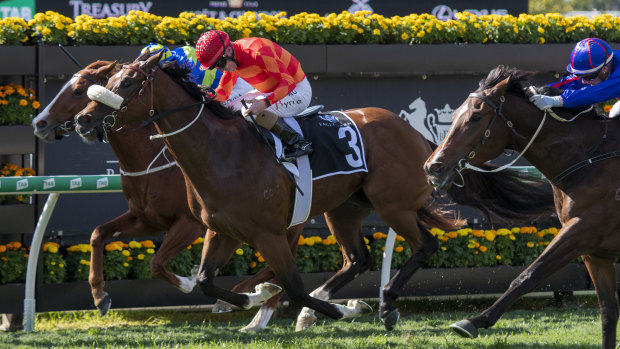 Jim Byrne (red silks) rides Apache Chase to victory in Brisbane.