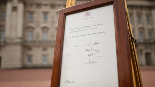 A notice is placed on an easel announcing the birth of the new Royal baby, in the forecourt of Buckingham Palace.
