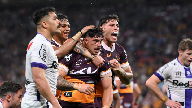 Kotoni Staggs is congratulated by teammates after scoring a try against Melbourne during the 2023 finals.