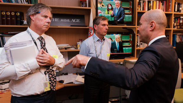 Treasurer Josh Frydenberg visits the offices of The Sydney Morning Herald and The Age during the 2022 budget lock-up. Also pictured are Shane Wright and David Crowe.