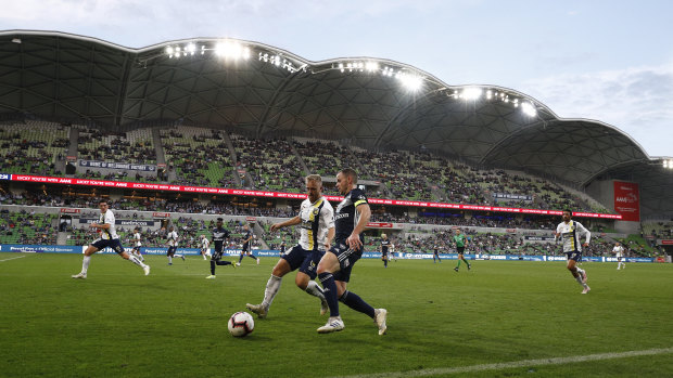 Lights, action: Victory's Leigh Broxham charges up the wing at AAMI Stadium.