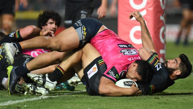 Jason Taumalolo barges over the top of James Tamou to score.