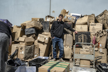 Aftershock PC co-owner Richard Noble pictured in October  after the flood with a pile of damaged stock.