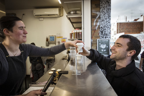 Local tech worker Ben Feald receives his $3 coffee during Mile End Brunswick’s morning happy hour.