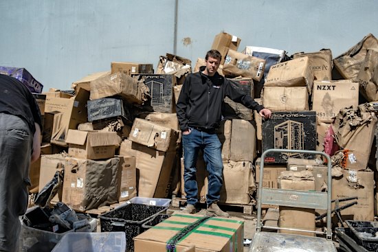 Aftershock PC co-owner Richard Noble pictured in October  after the flood with a pile of damaged stock.