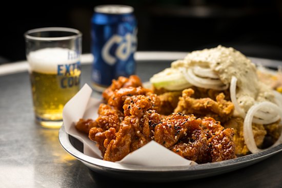 Fried chicken washed down with Cass beer at Seven Star Pocha in Koreatown. 