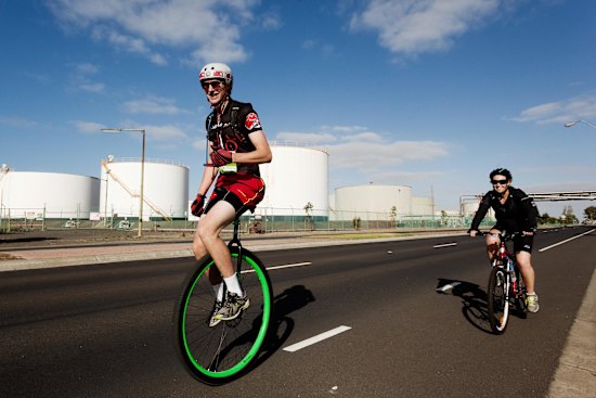 Riders pass silos on Kororoit Creek Road, Williamstown North in the 2014 MS Melbourne Cycle.