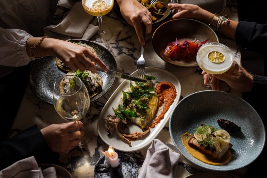 A parilla grill and vertical rotisserie fire the menu at Esteban.