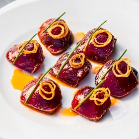 Pepper-crusted yellowfin tuna with tomato oil.