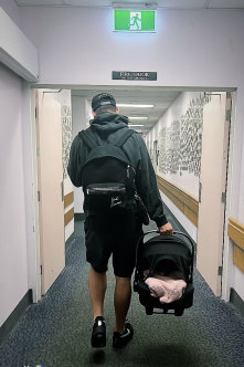 Joey Manu leaves hospital with his newborn daughter.