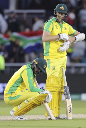 Australia's Nathan Lyon, left, and teammate Jason Behrendorff react after losing to South Africa.