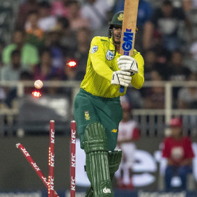 South Africa's captain Quinton de Kock is bowled by Mitchell Starc.