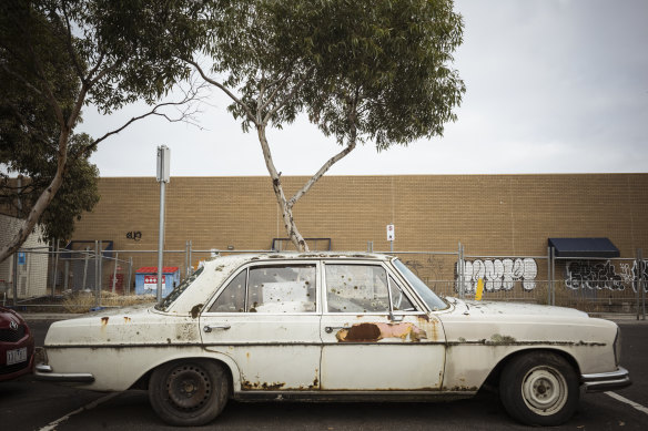 An old Mercedes-Benz covered in rust.