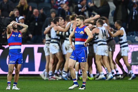 Gary Rohan and the Cats celebrate after their dramatic win as the Dogs feel the pain.