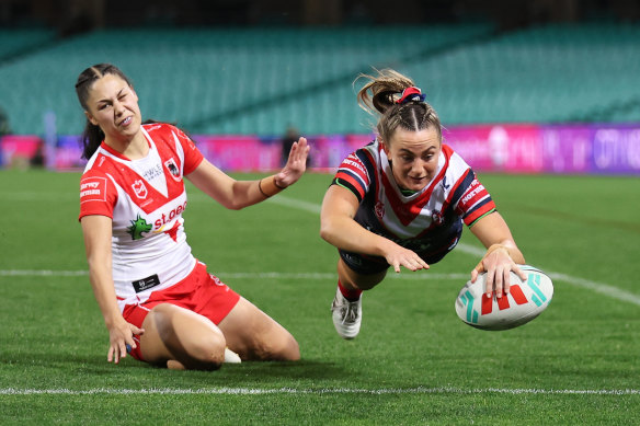 Brydie Parker of the Roosters dives over for a try.