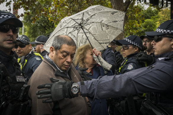 Members of Melbourne’s Jewish community are escorted past pro-Palestine protesters.