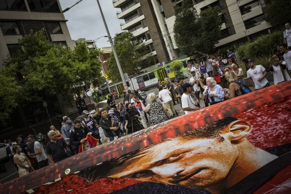 Novak Djokovic supporters gather outside the Park Hotel to protest against his detention.