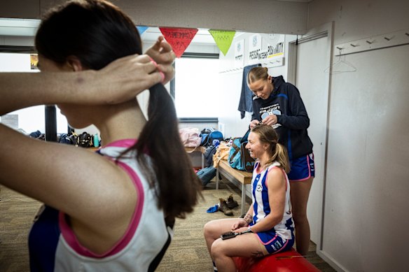 Players get their hair braided before the game. 