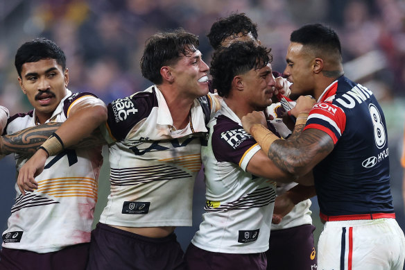 Spencer Leniu (right) of the Roosters exchanges heated words with Kotoni Staggs of the Broncos in Las Vegas.