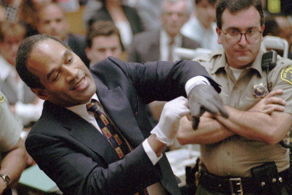 OJ Simpson grimaces as he tries on one of the leather gloves prosecutors say he wore the night his ex-wife Nicole Brown Simpson and Ron Goldman were murdered.