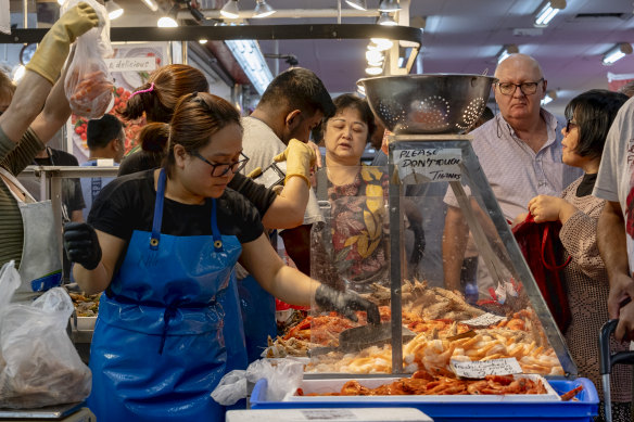 Shoppers pack Footscray Market to buy seafood on Saturday.
