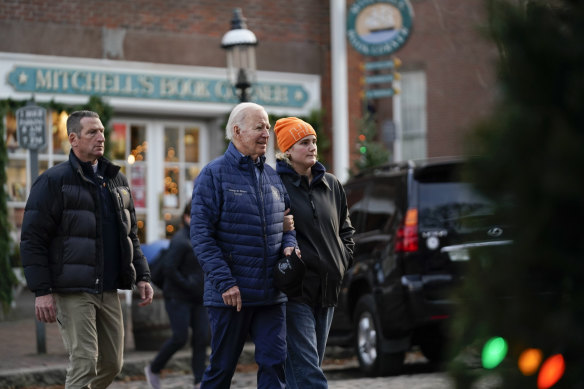 President Joe Biden walks with his granddaughter Maisy Biden as he visits local shops with family in Nantucket on Saturday.