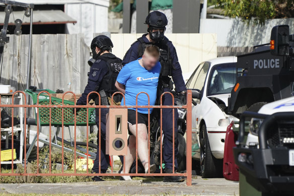 SWAT police bring out a man from the house he was barricading himself inside in Corio on Sunday.
