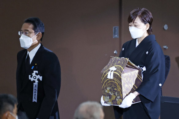 Akie Abe, wife of former Japanese Prime Minister Shinzo Abe, carries a box holdings Abe’s ashes during the state funeral.