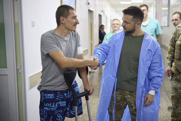 Ukrainian President Volodymyr Zelensky shakes hands with a wounded soldier in a city hospital in Odesa on Friday (Ukraine time).