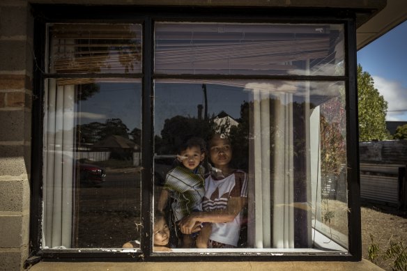 Aye Win Tin and sons Ro Poh Htoo (left) and Ro Say Htoo wait for Eh Ro to come home for lunch.