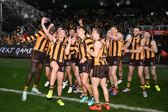 Hawks players celebrate with what has become a trademark selfie after their thumping win over the Roos.