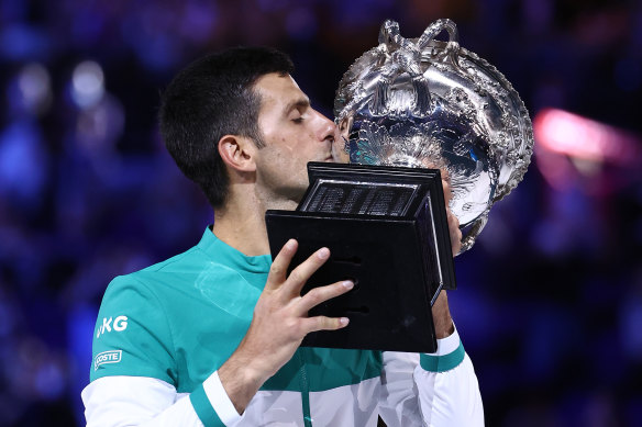 Novak Djokovic holds the Australian Open trophy in 2021.