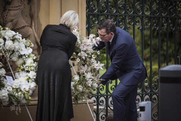 Premier Daniel Andrews and wife Catherine lay a wreath in honour of the Queen at Government House on Friday.