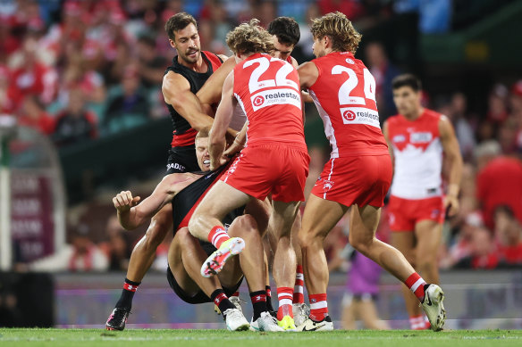 Swans players wrestle with Peter Wright.