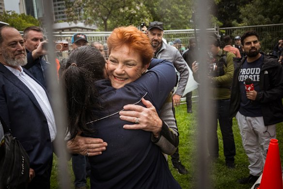 One Nation leader Pauline Hanson hugs a supporter before addressing the crowd at the Put Australia First rally at Melbourne's Flagstaff Gardens in November 2025.