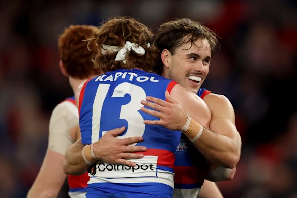 Lachlan McNeil of the Bulldogs is congratulated by teammates after kicking a goal.