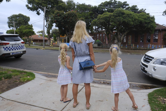 Ella and daughters Alexia and Jasmine, who are pupils at Sandringham Primary School, look on after the school was partly destroyed in a fire.