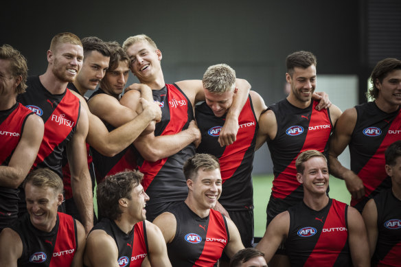 Nate Caddy is the centre of attention as the Dons horse around during a photo shoot.