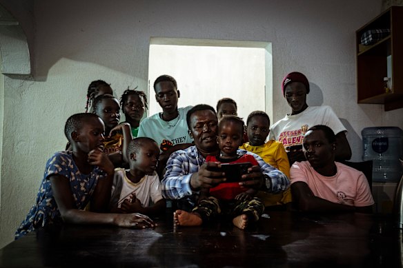 Fred Alimet watches YouTube clips with his family.