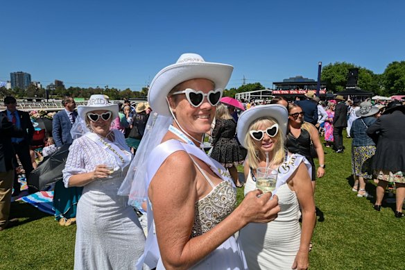 Bridal party celebrates at the races.