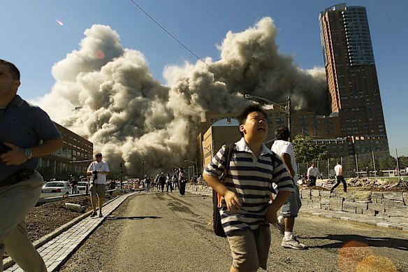 People flee as the north tower of the World Trade Center collapses. 
