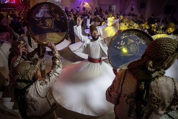 Whirling Dervishes and traditional performers dance during the mens wedding party of Mr. Muwaffaq Al-Badawi at a wedding hall in Damascus, Syria.