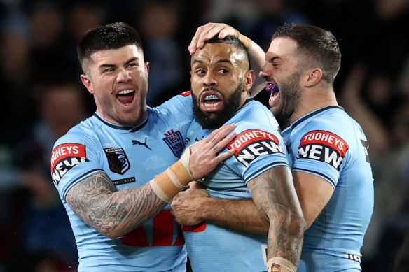 Josh Addo-Carr celebrates a try with James Tedesco and Bradman Best.