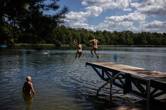 Nudists jump into a lake in Zossen, Germany. 