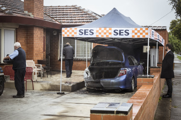 Detectives and arson investigators on the scene where a car was torched days after shots were allegedly fired at a Fawkner house with links to crime figure Mohammed Oueida.
