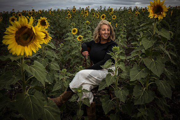 Laiken Britt, among the freshly bloomed crop of Sunflowers on her farm in Dunnstown.