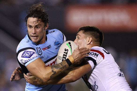 Nicho Hynes is tackled by Victor Radley.