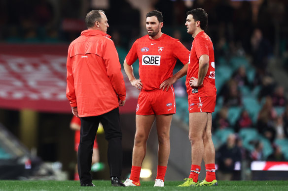 Tom and Paddy McCartin talk with coach John Longmire.